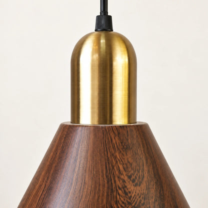 Close-up of the brass-tone cap, cord grip and wood-grain metal shade