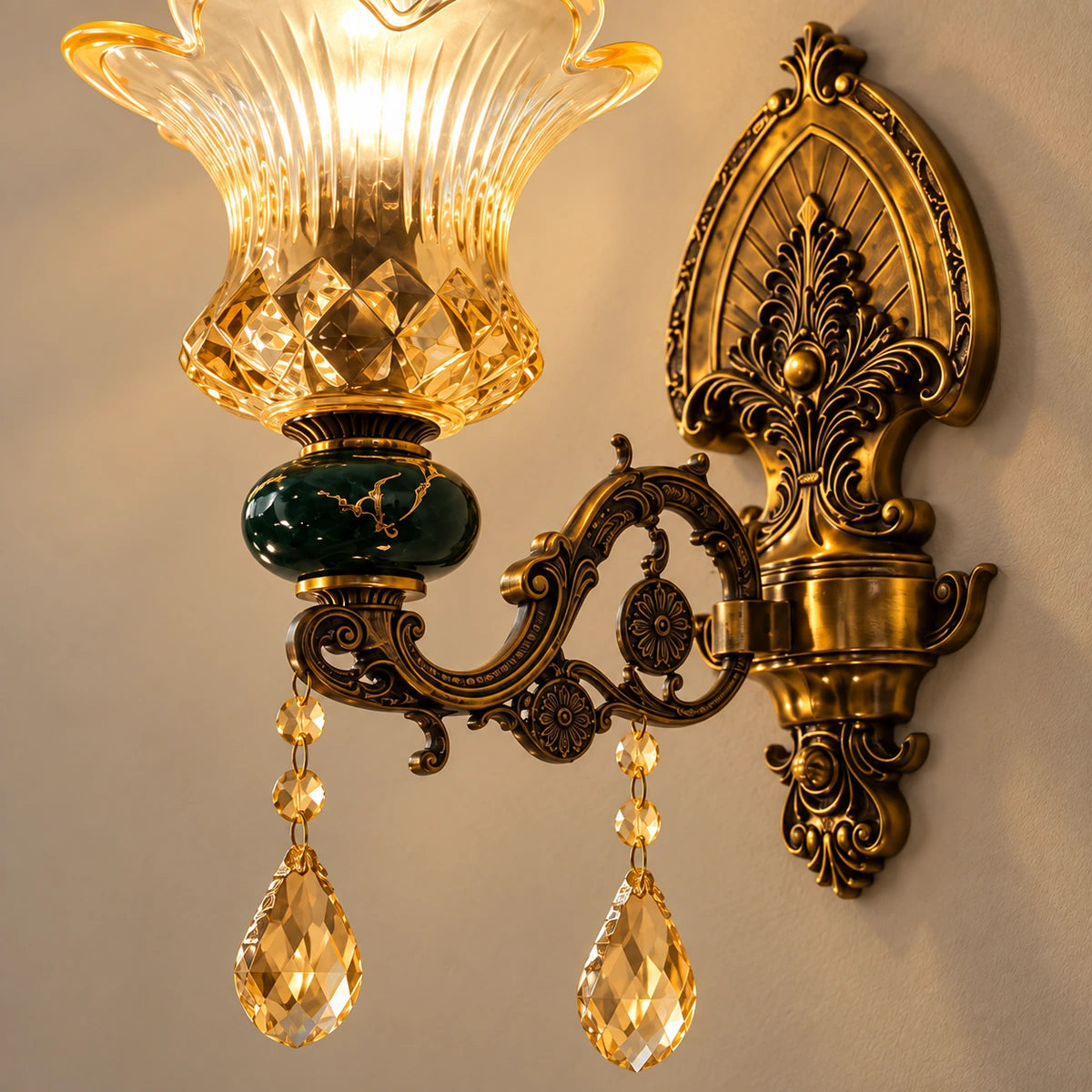 Close-up of the amber glass shade, green accent and antique-brass scrollwork