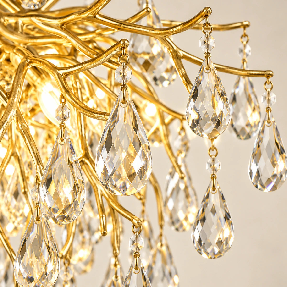 Close-up of clear teardrop crystals attached to gold branches