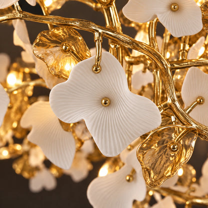 Close-up of white porcelain leaves and warm metallic branches