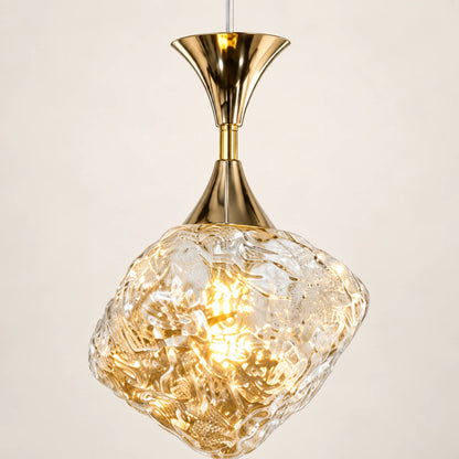 Close-up of textured glass and polished gold attachment