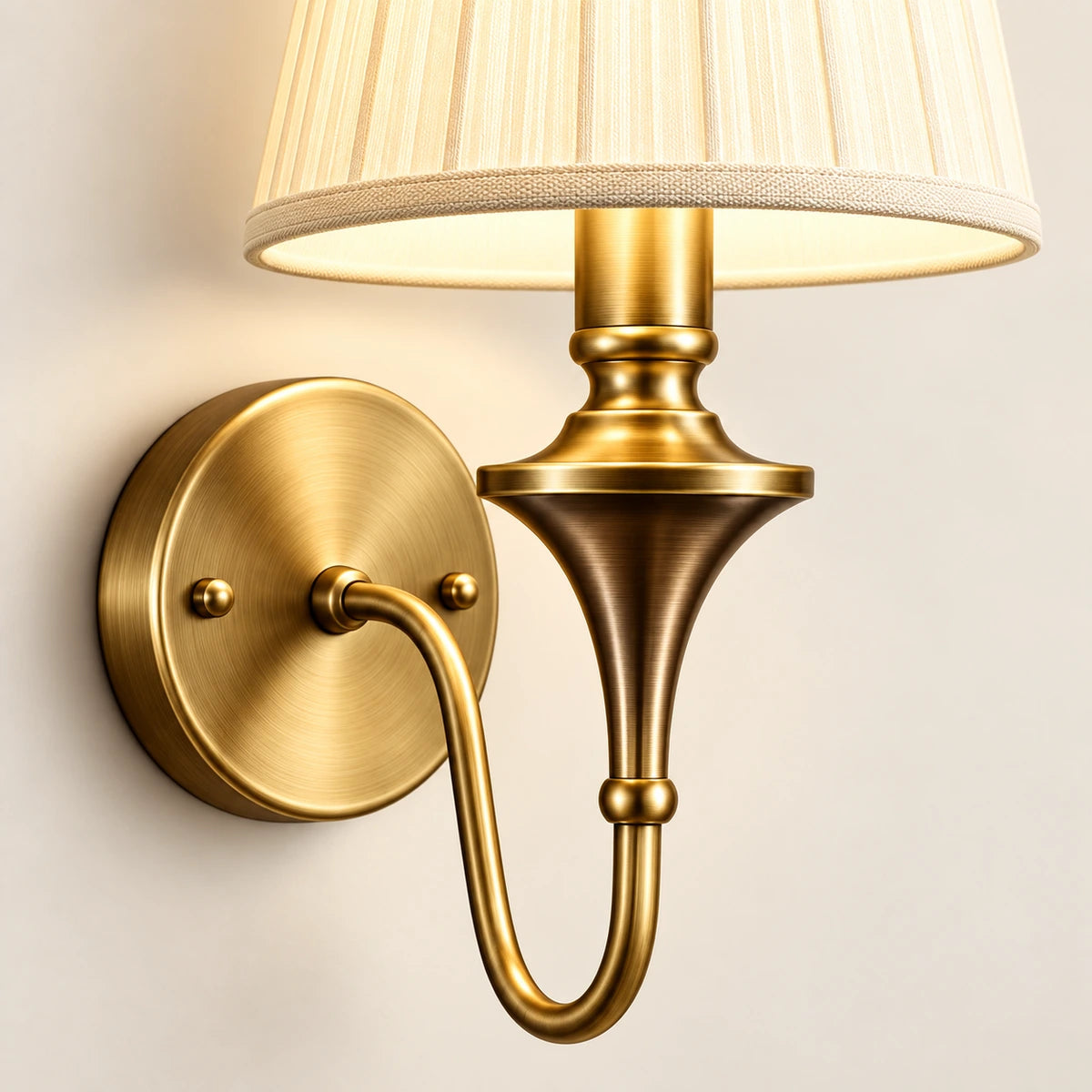 Close-up of the pleated shade, turned stem, curved arm and round wall plate
