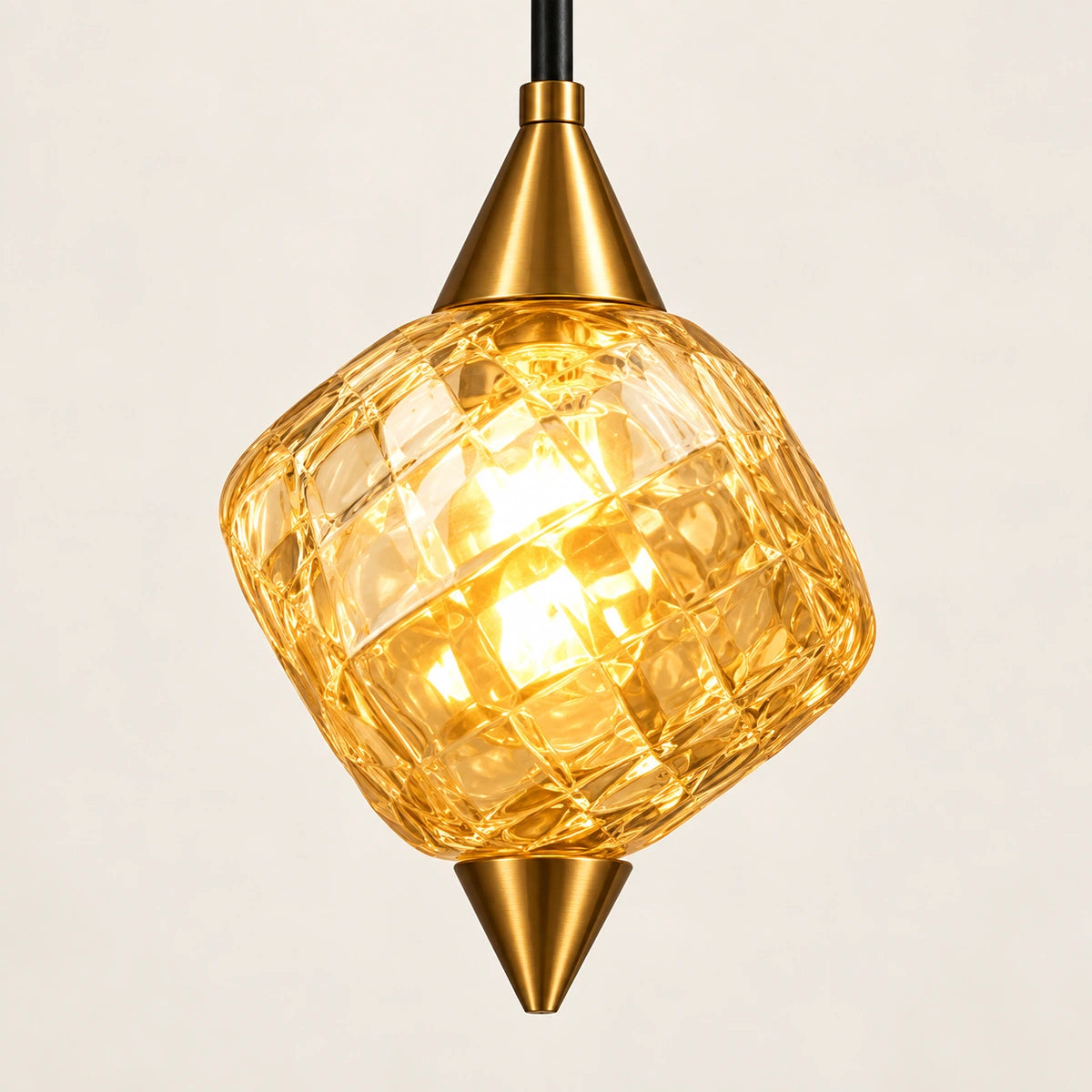 Close-up of the faceted amber glass pendant and gold-tone caps