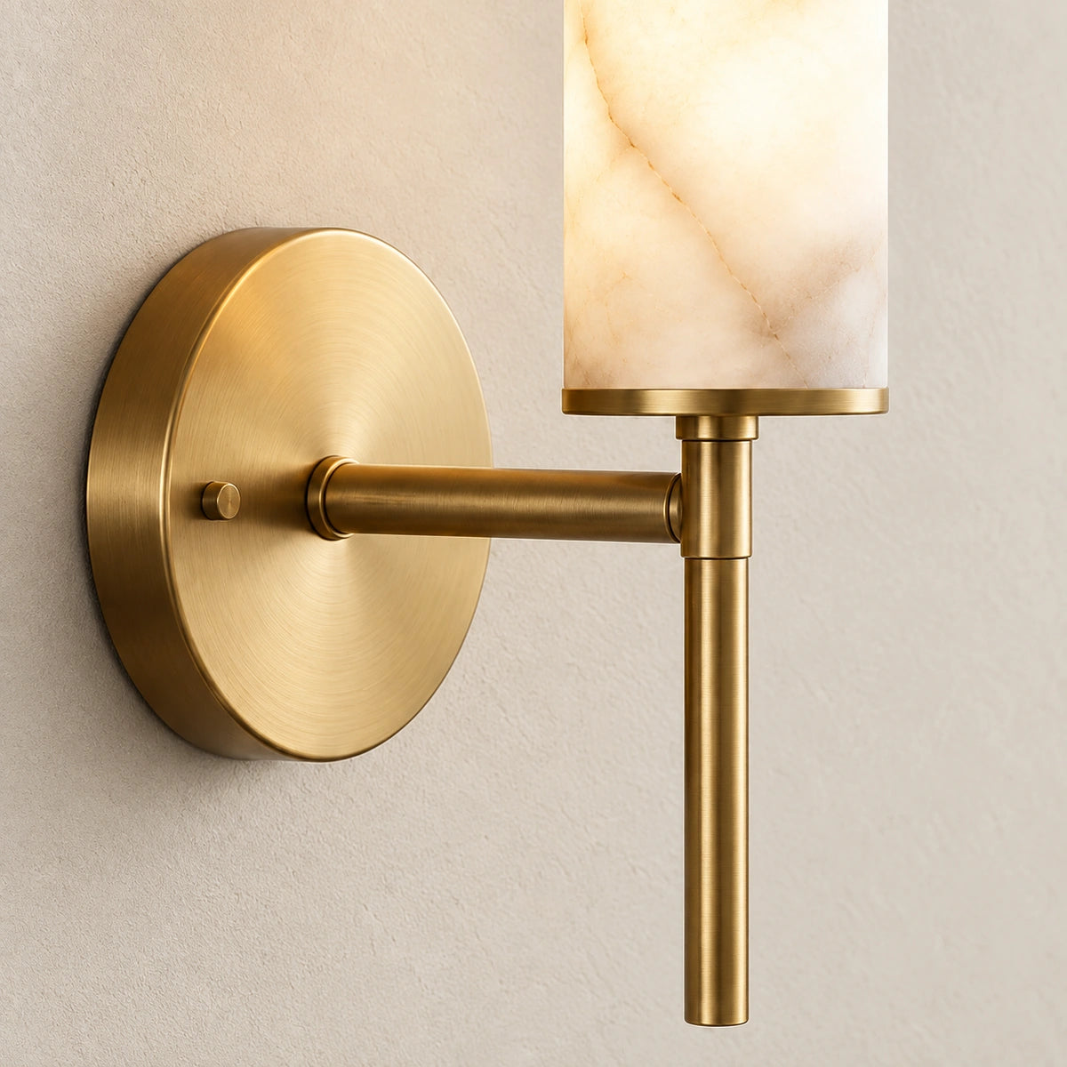 Close-up of the translucent cylinder, round backplate and brass-tone arm connection