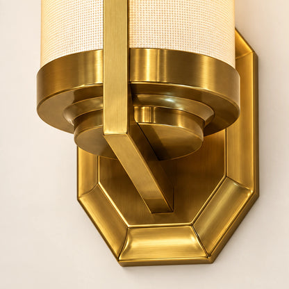 Close-up of the fabric shade, brass-tone collar, support and faceted wall plate