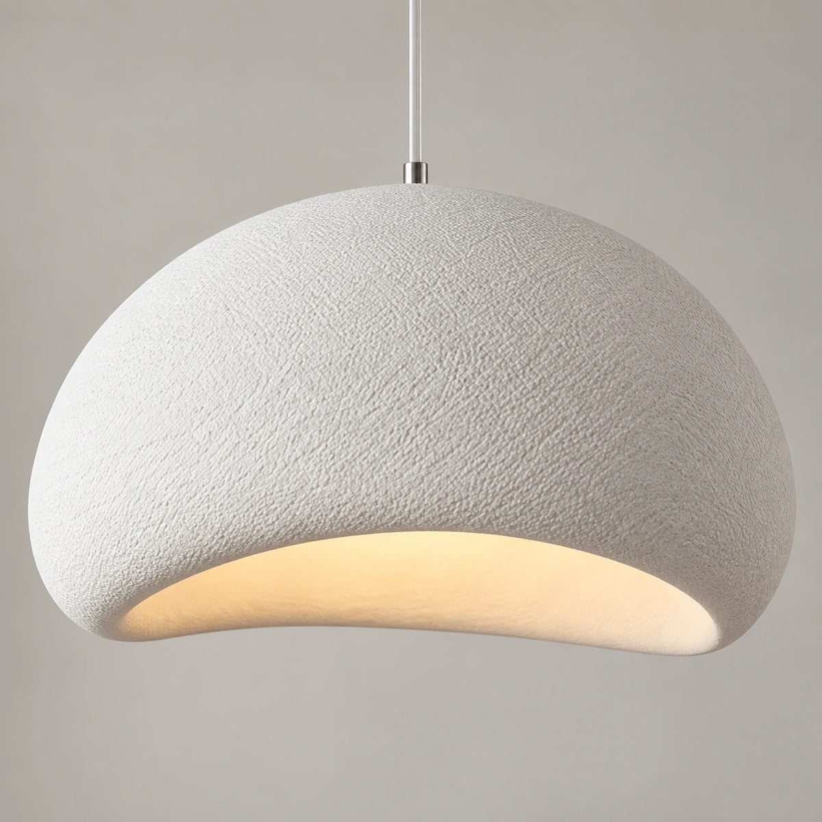 Close-up of textured dome surface and asymmetric illuminated opening