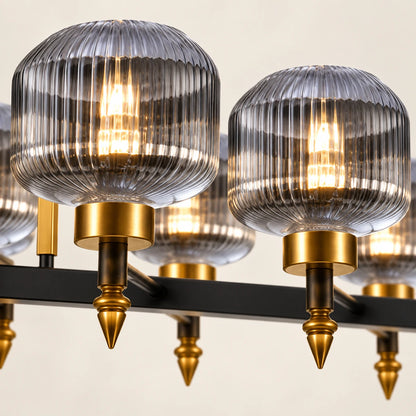 Close-up of ribbed smoke glass, antique-gold holders, pointed finials and black bar