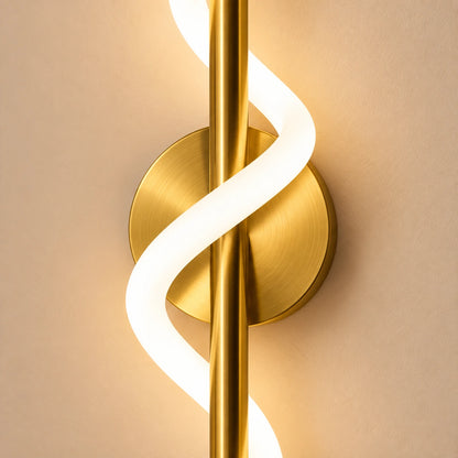Close-up of the illuminated ribbon crossing the gold bar and round wall plate