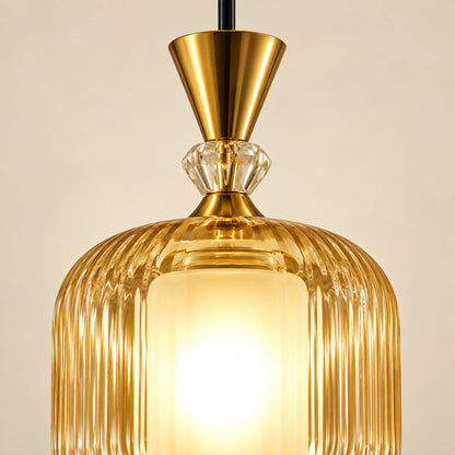 Close-up of ribbed amber glass, frosted inner cylinder and gold-tone cap
