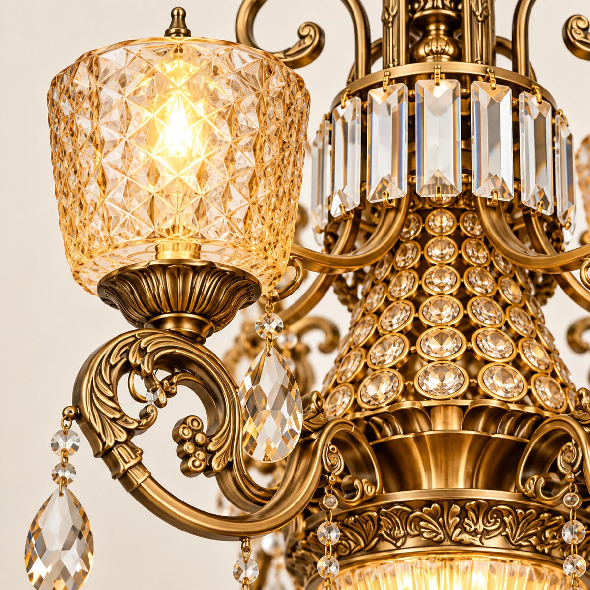Close-up of amber cut-glass shade, gold scroll arm and clear crystal rods