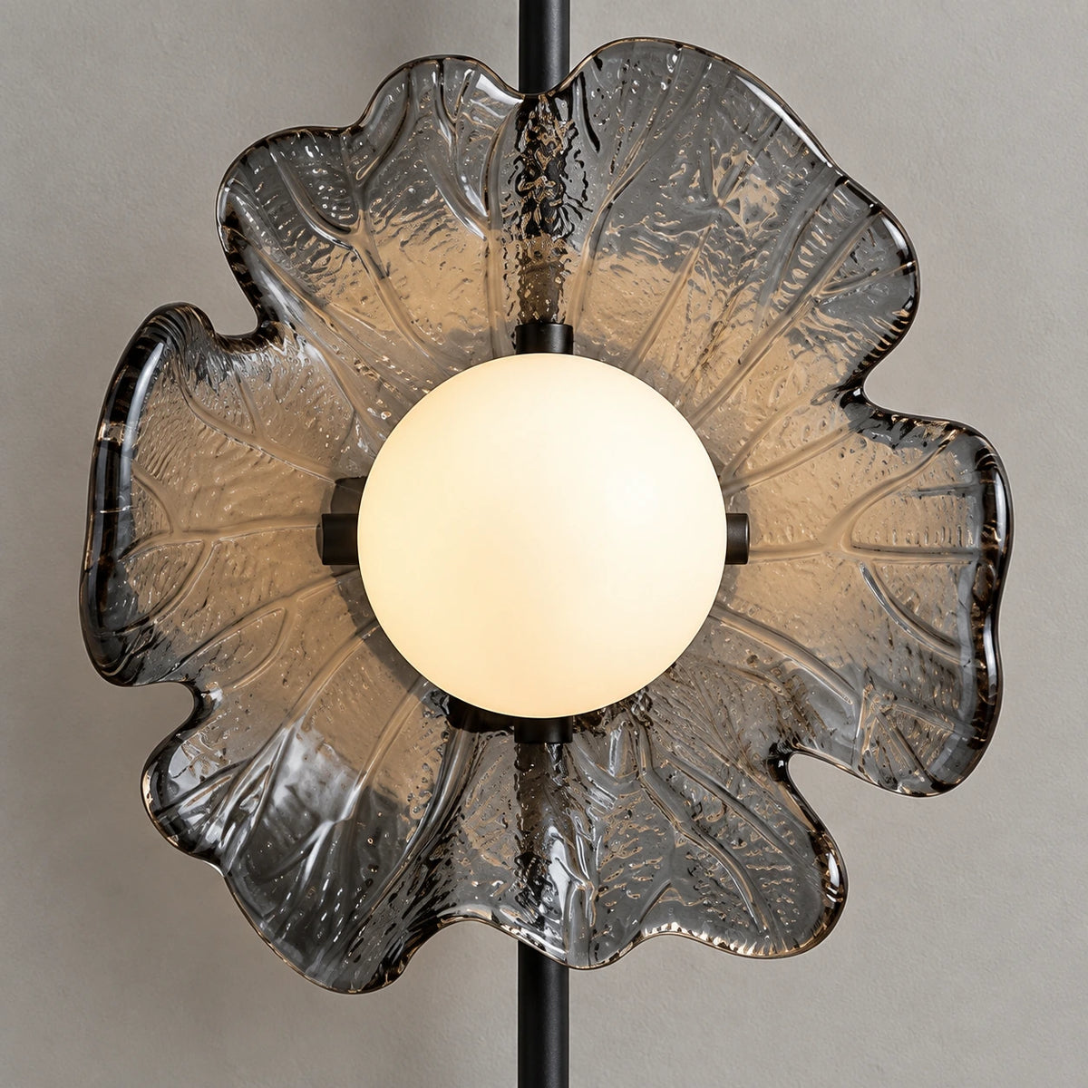 Close-up of the illuminated globe and textured flower-shaped plate