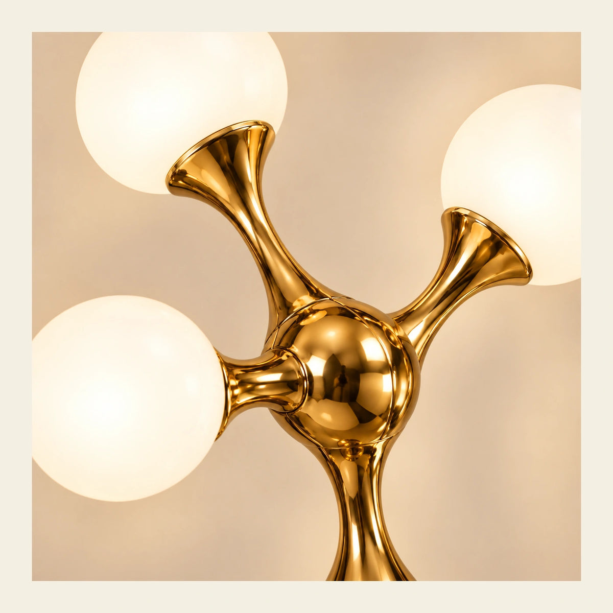 Close-up of opal globes, curved arms and polished gold junction