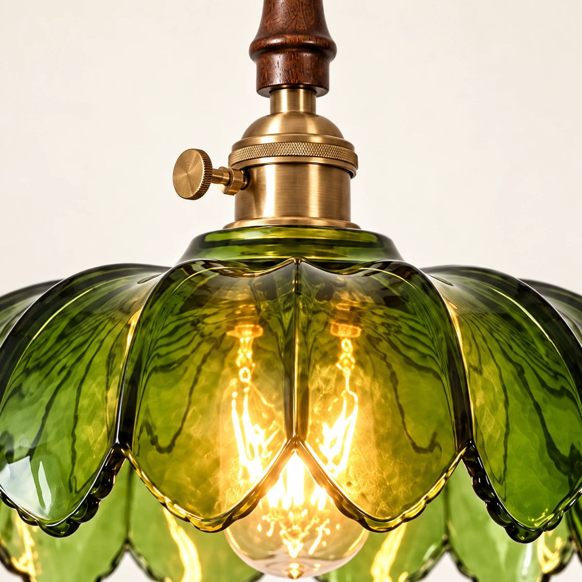Close-up of the turned wood neck, brass socket and scalloped green glass
