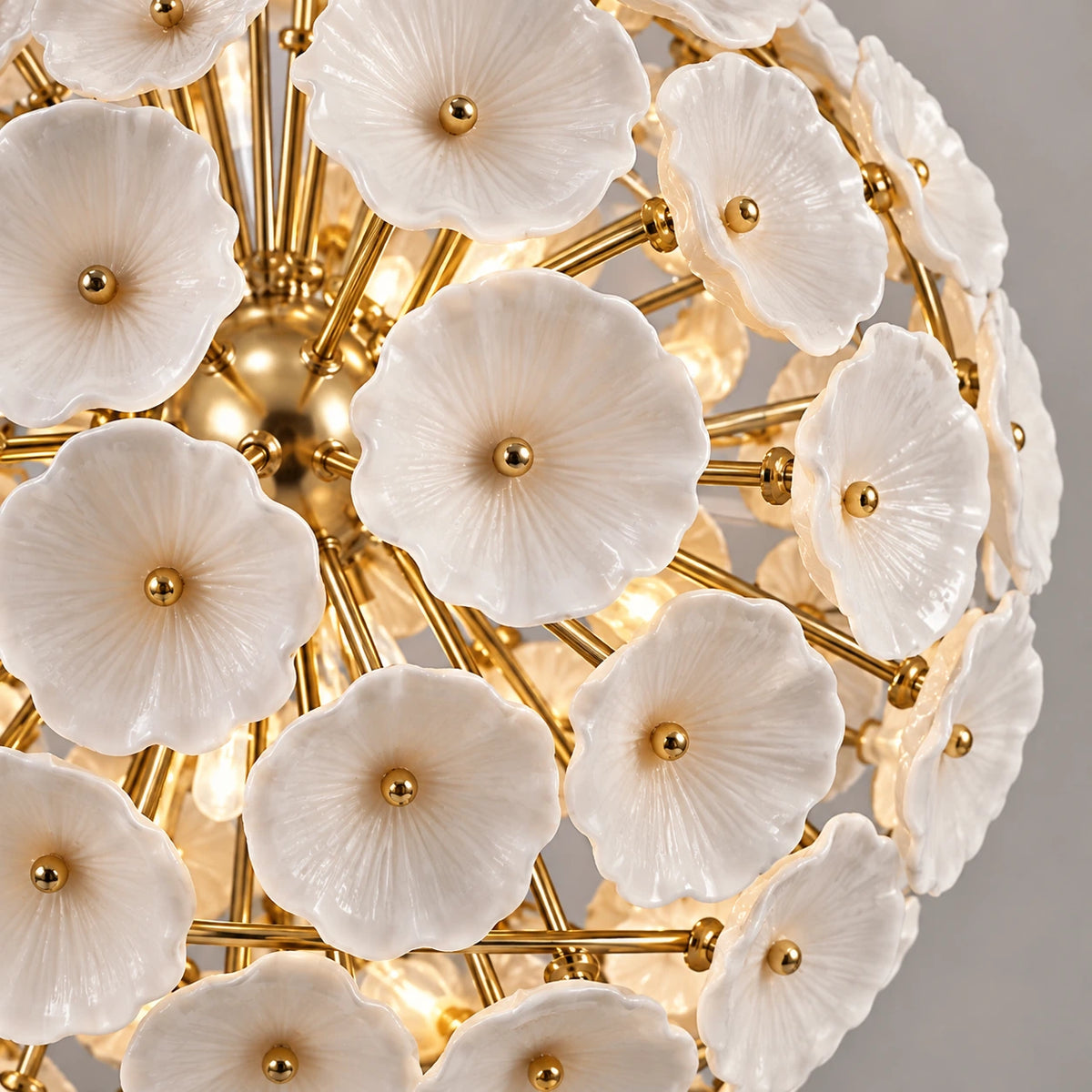 Close-up of ceramic flowers and gold-tone chandelier structure