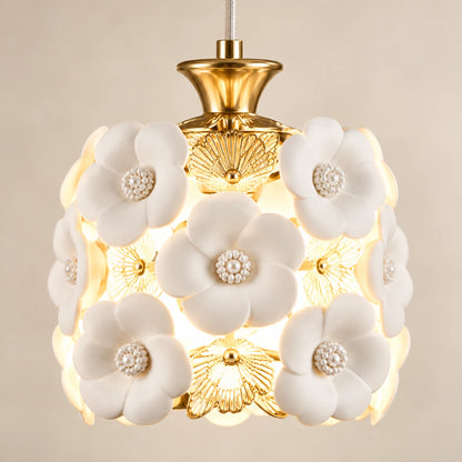 Close-up of ceramic flowers, gold-tone filigree and shade attachment