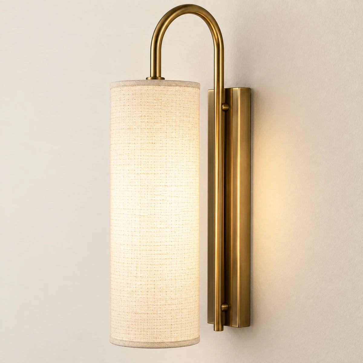 Close-up of the woven cylindrical shade, curved arm and wall plate