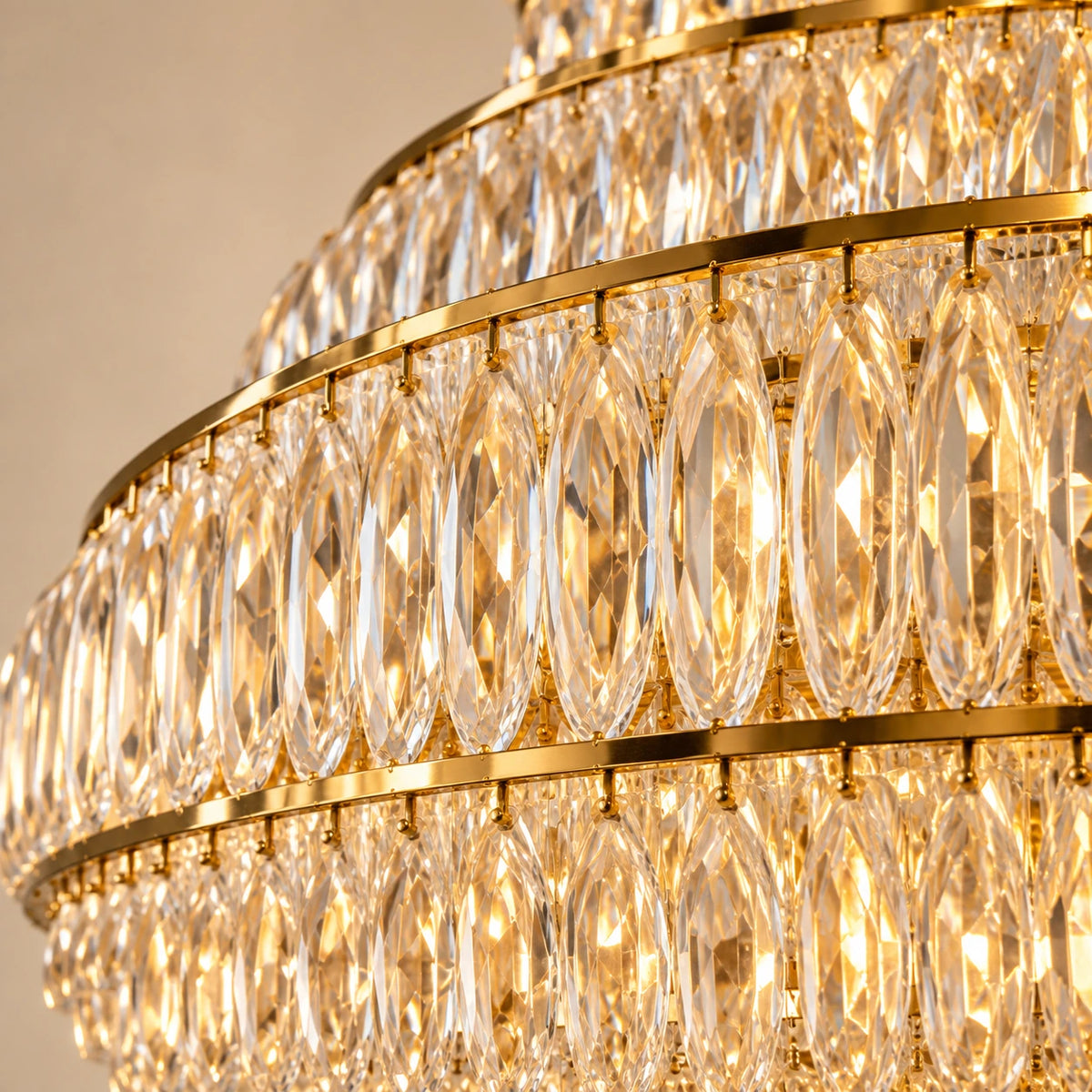 Close-up of the elongated faceted crystal drops and gold-toned tier rails