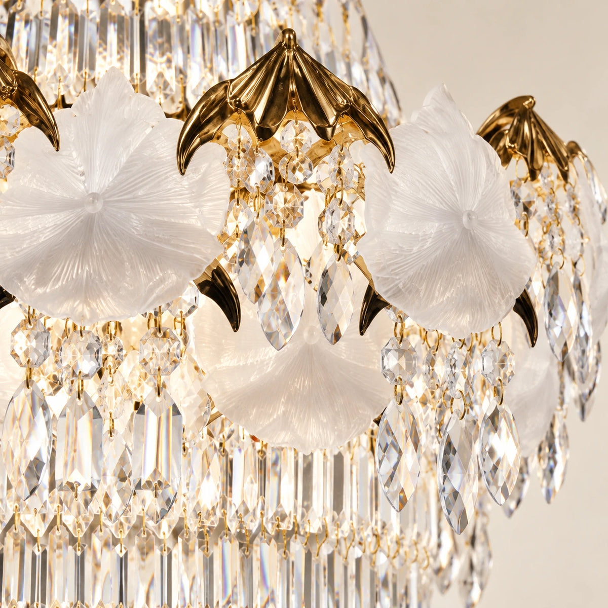 Close-up of the frosted white floral glass, gold-toned crowns and crystal pendants