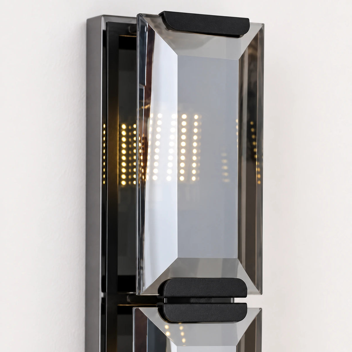 Close-up of the bevelled mirrored panel, smoked side frame and tier connector