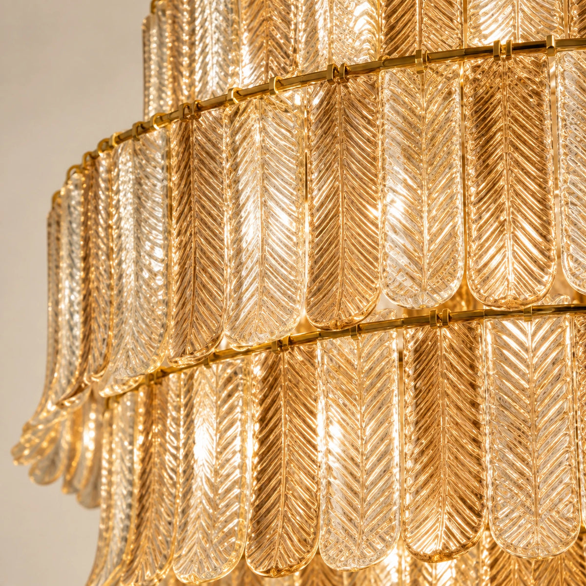 Close-up of the tiered ribbed glass elements and gold-toned support rings