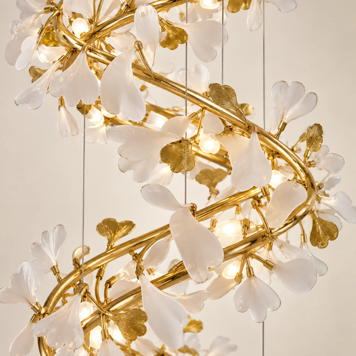 Close-up of the white leaf details, gold branching frame and suspension cables
