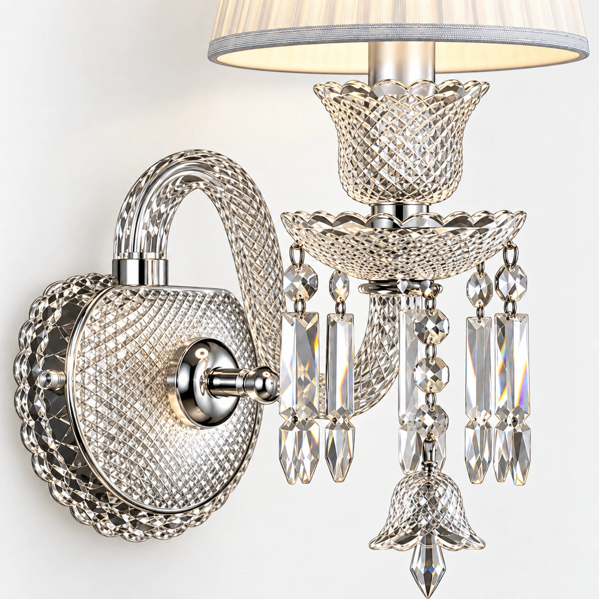 Close-up of textured wall plate, curved arm, bobeche and crystal fringe