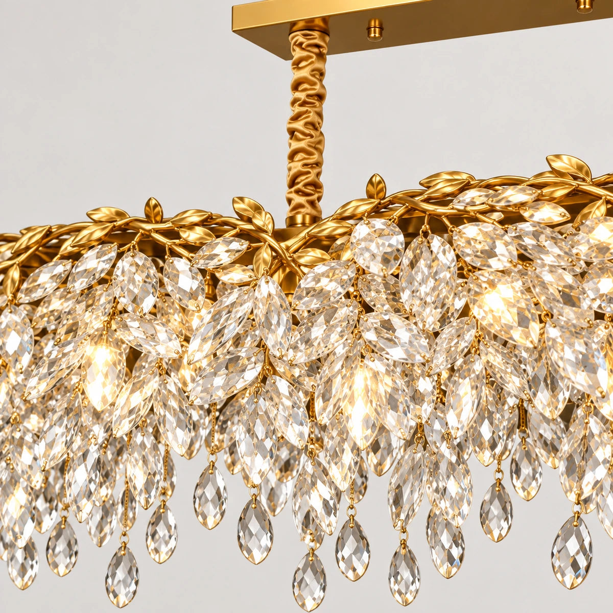 Close-up of the suspension, gold-tone frame and faceted crystal drops