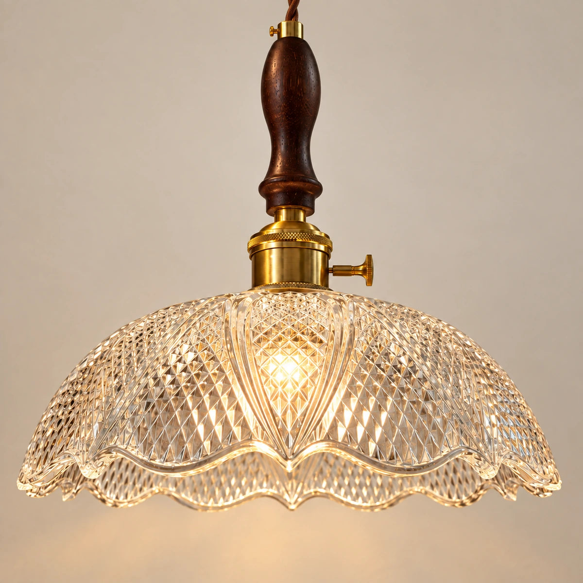 Close-up of diamond-cut glass scalloped edge and wood-metal connection
