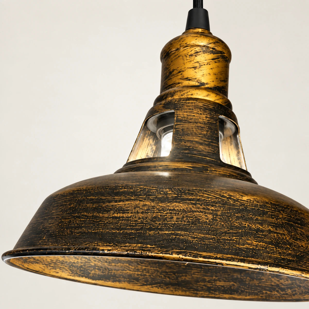 Close-up of distressed antique-gold finish, metal rim and raised neck