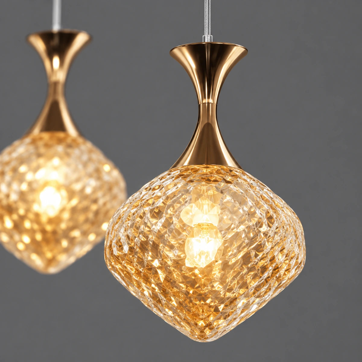 Close-up of faceted amber glass shade and gold cap connection
