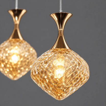 Close-up of faceted amber glass shade and gold cap connection