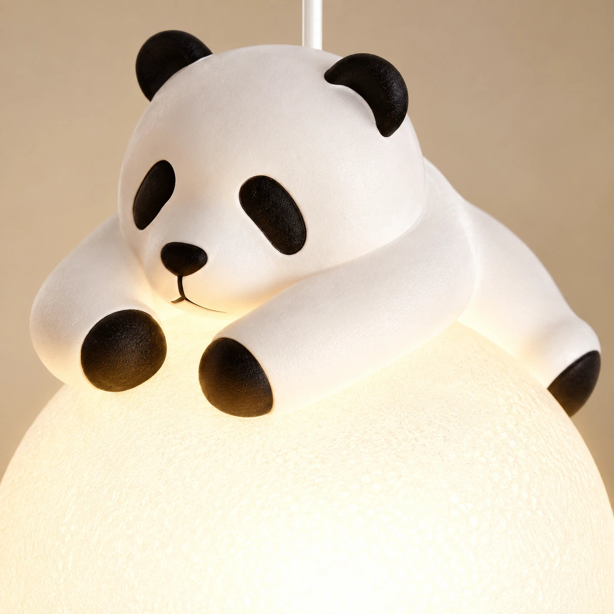 Close-up of the white resin panda and textured acrylic globe