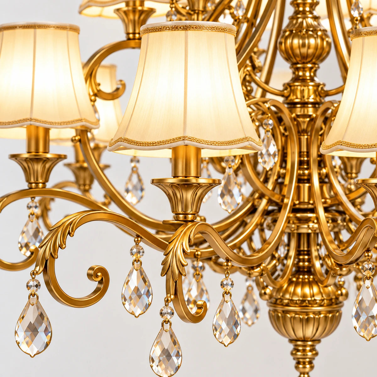 Close-up of an ivory shade, scrolling gold arm and crystal drops