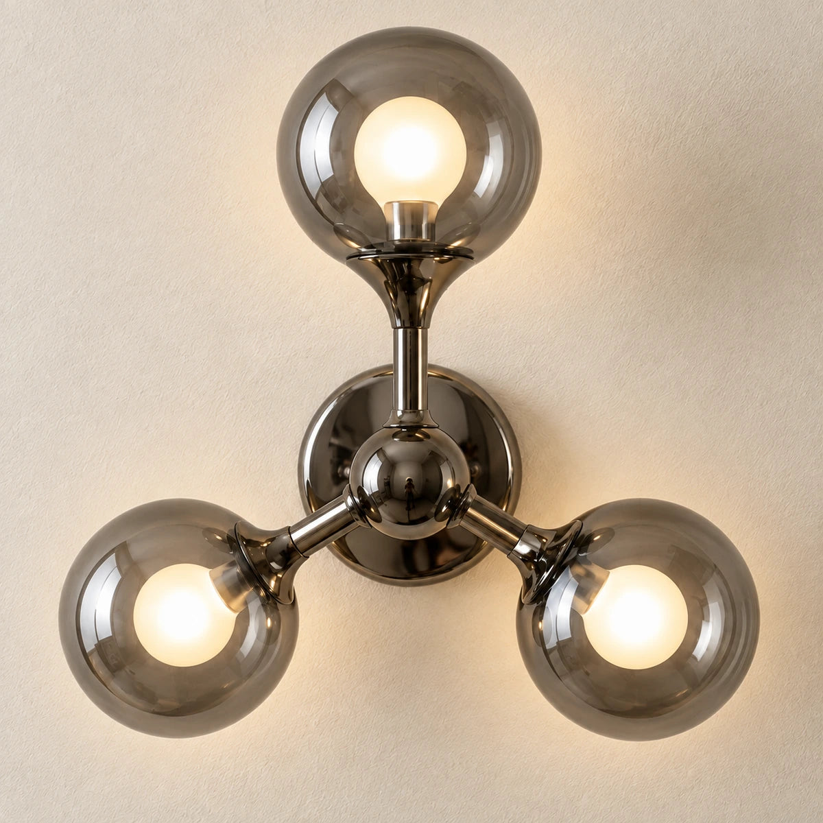 Close-up of smoke glass globes and connected metal arms
