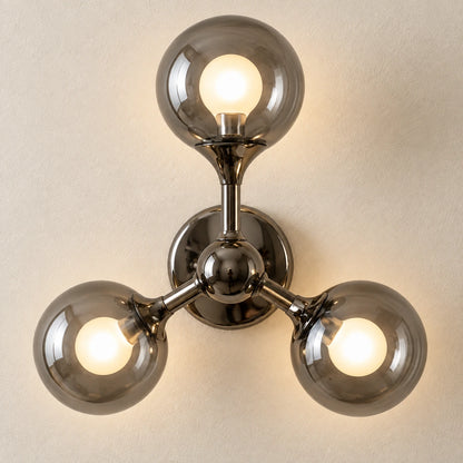 Close-up of smoke glass globes and connected metal arms