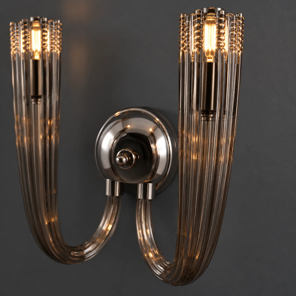 Close-up of smoked ribbed glass, warm bulb, chrome holder and arm connection