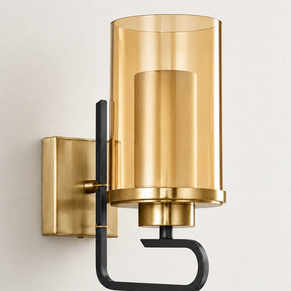 Close-up of the Aurelia sconce's amber outer glass, frosted inner cylinder and black open-hook frame