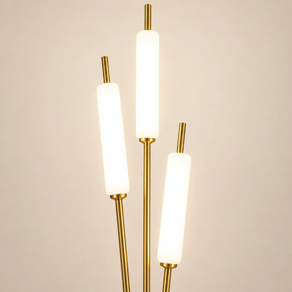 Close-up of three white illuminated tubes and gold stem connections