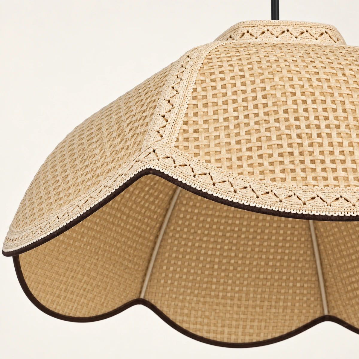 Close-up of off-white woven fabric, decorative trim and scalloped edge