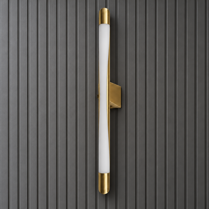 Close-up of the Serein wall light's curved white diffuser, gold end caps and angular wall bracket