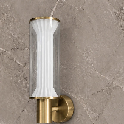 Close-up of fluted white diffuser and brushed gold wall mount