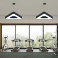 Two TriHalo triangle ring LED pendants in a fitness studio