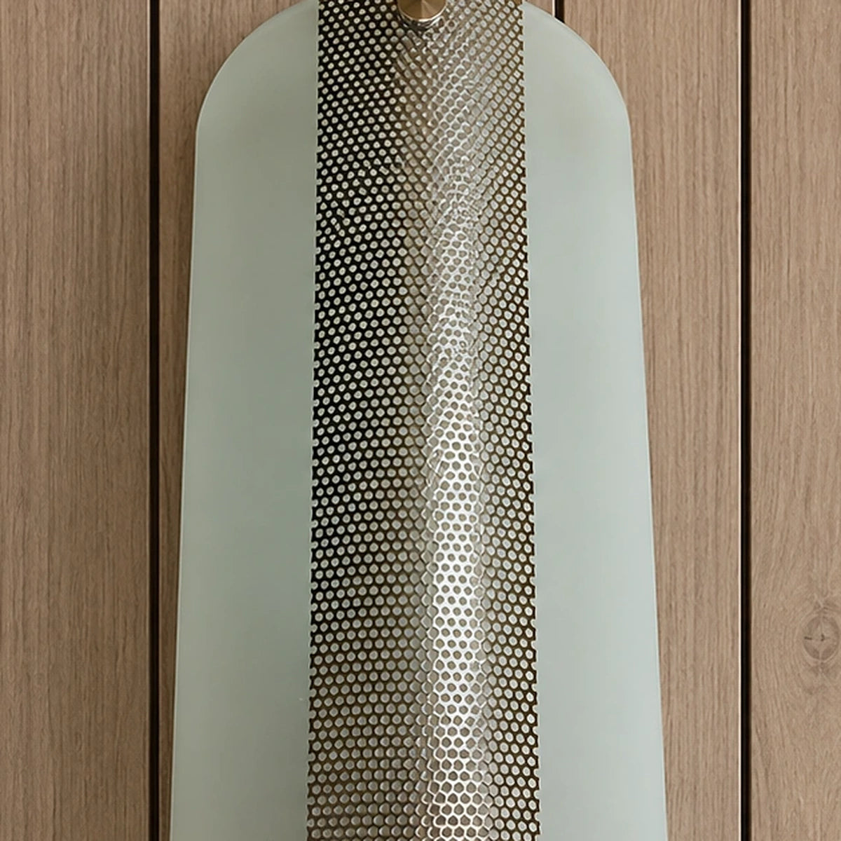 Detail of the curved frosted glass and perforated centre panel