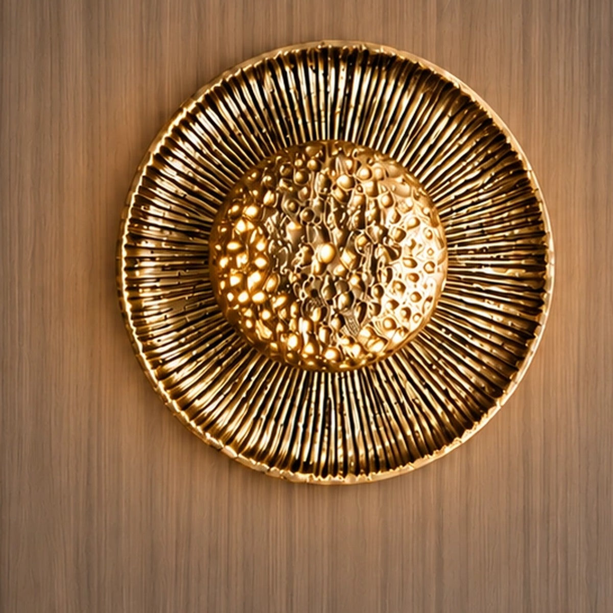 Gold sunburst wall light illuminated