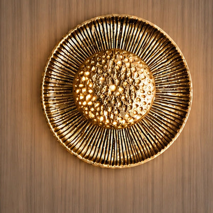 Gold sunburst wall light illuminated
