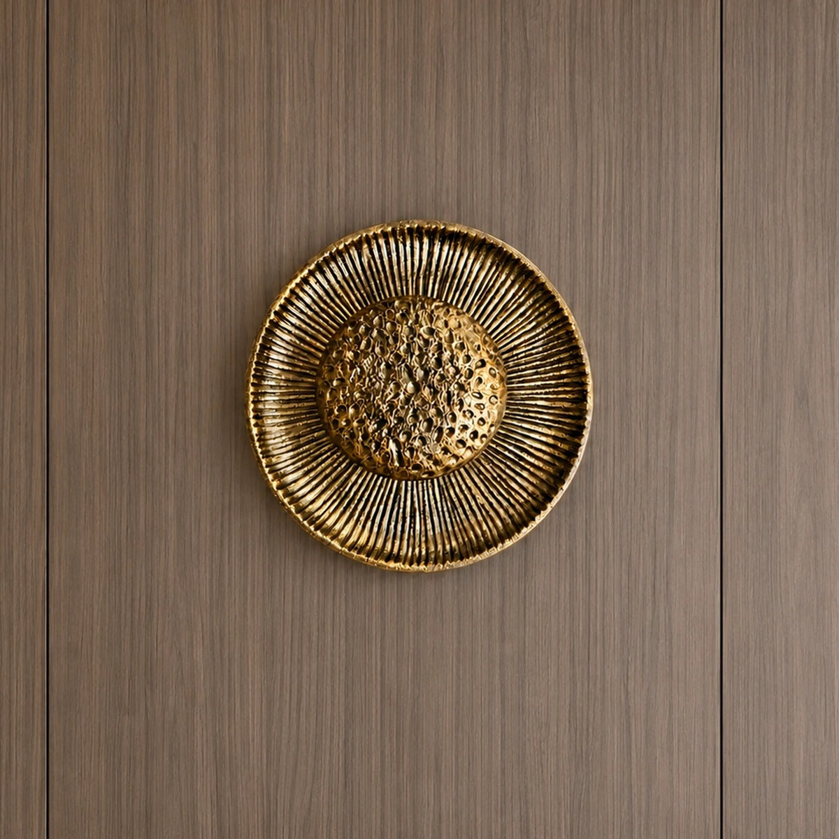 Gold sunburst wall light on a wood-panelled wall