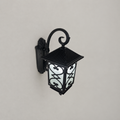 Heart-and-diamond panel wall lantern on a neutral wall, styled product overview