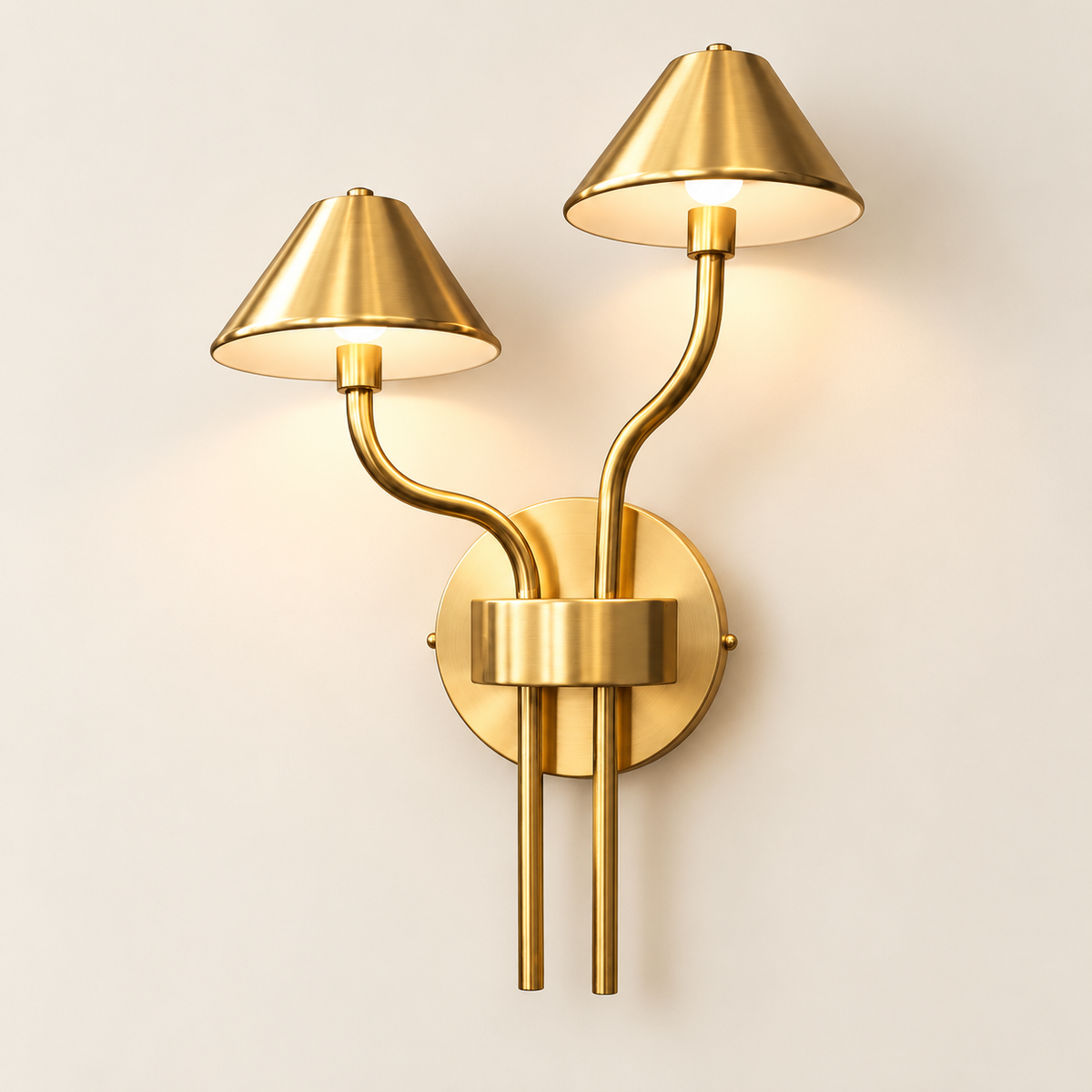 Auric brushed-gold LED wall light illuminated on a warm ivory studio wall
