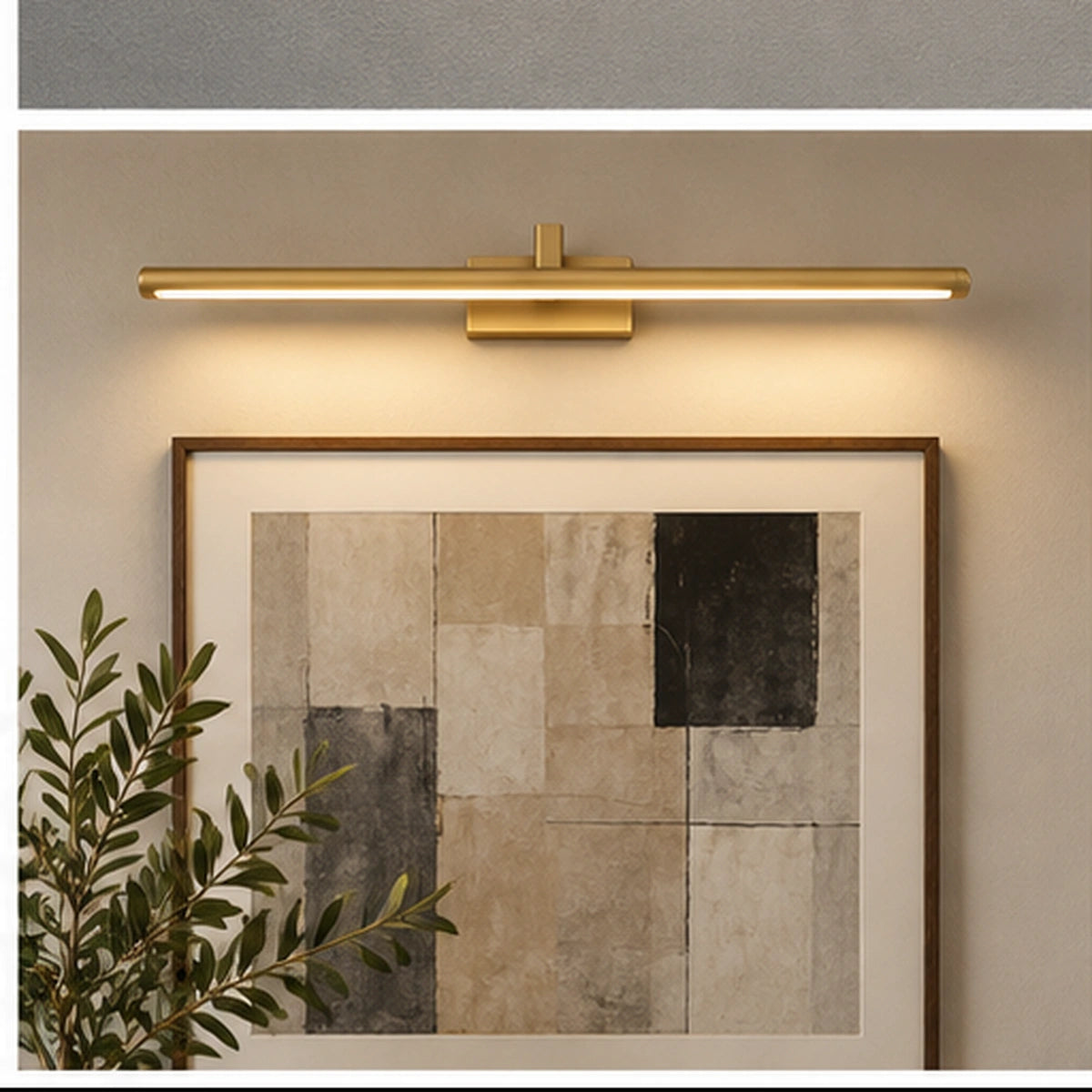 Gold slim linear picture light above framed artwork