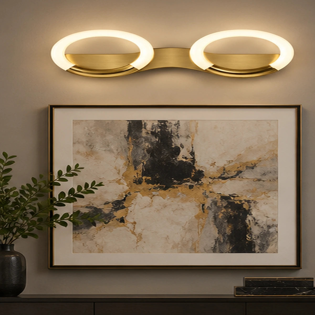 Antique-brass oval-ring wall light above artwork